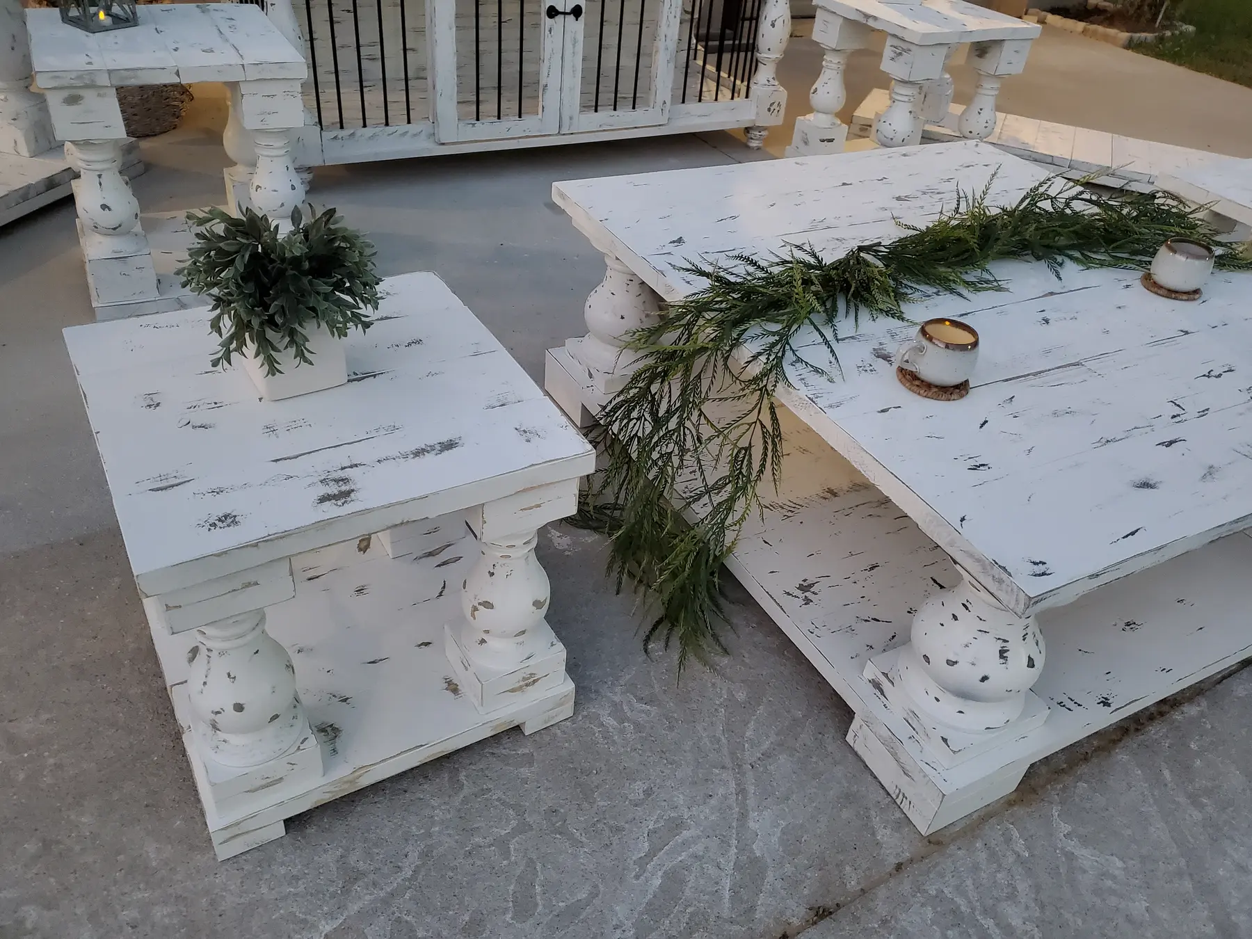 A close view of the distressed white coffee table and smaller companion table