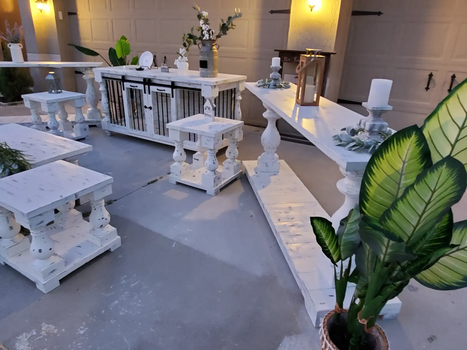 The long distressed white console beside the coffee tables and dog kennel