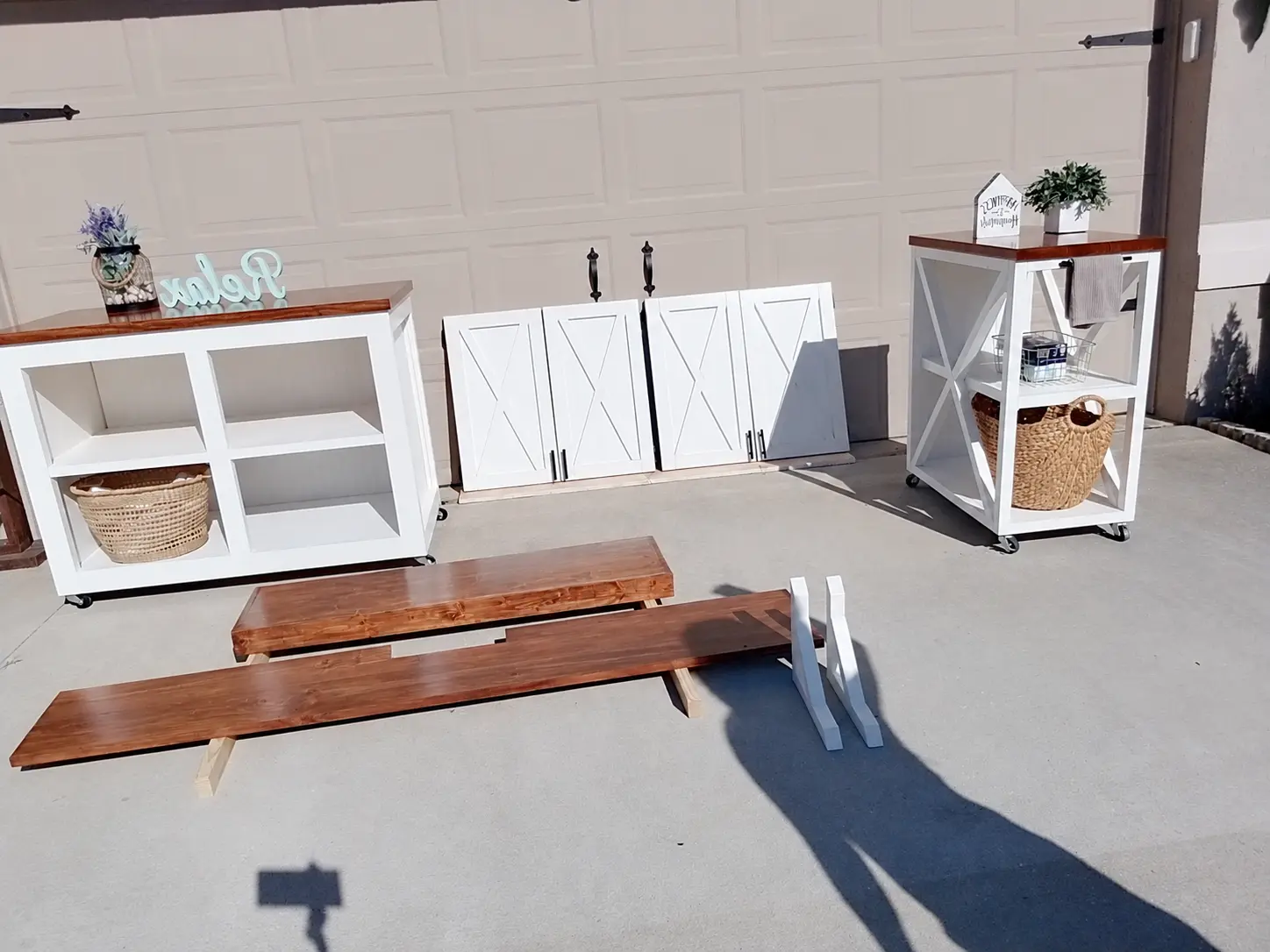 The custom laundry cabinetry, rolling storage and wood parts together before installation
