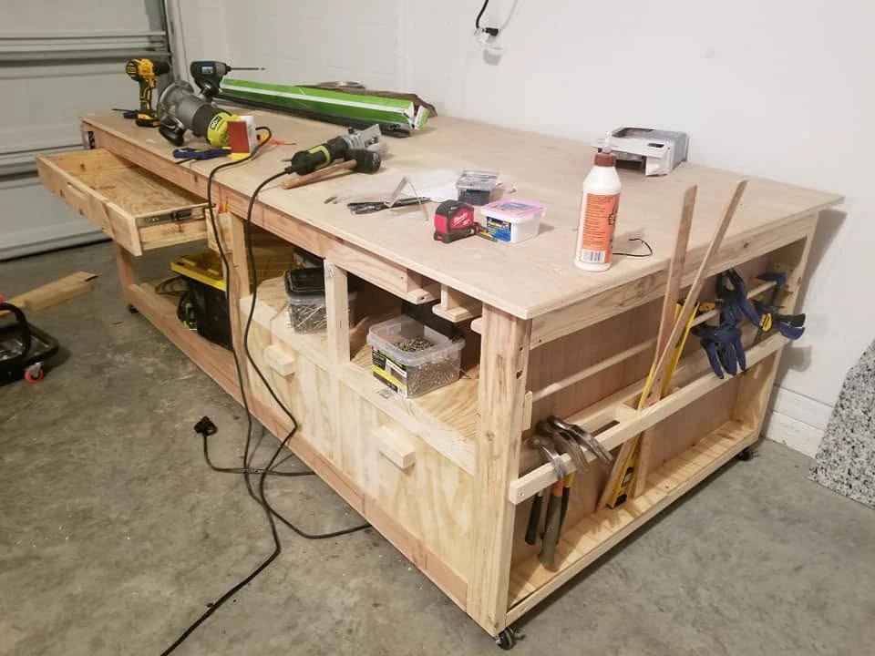 The workbench in use with a drawer, lower storage, and tools along the side
